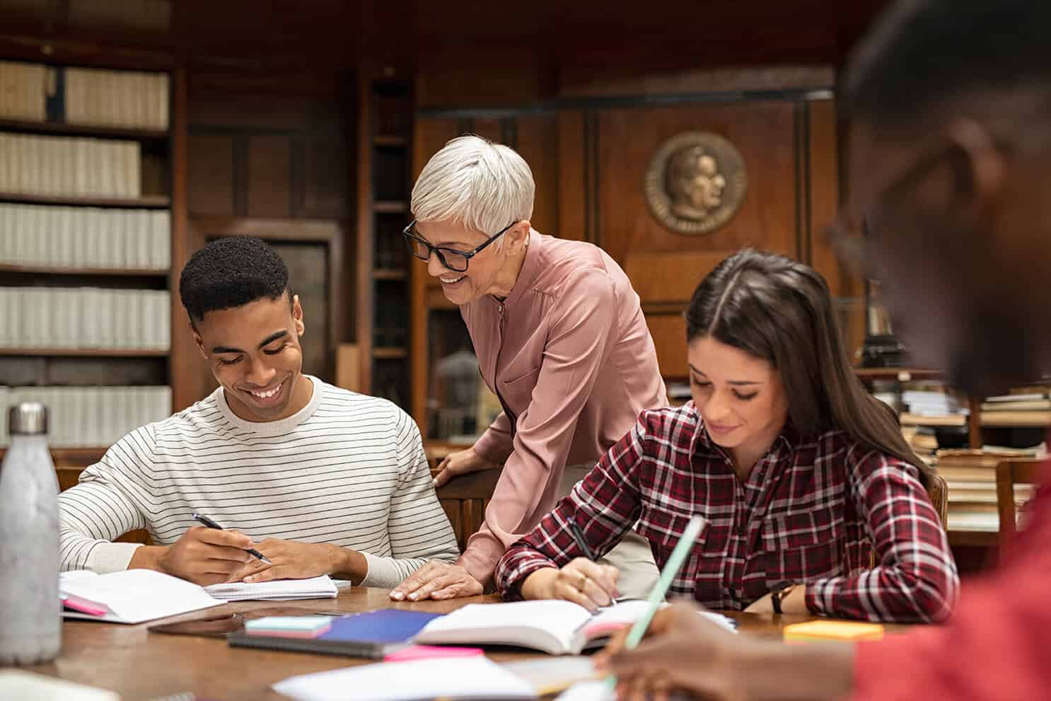 Senior Professor Helping Group Of Students Akqldtv.jpg